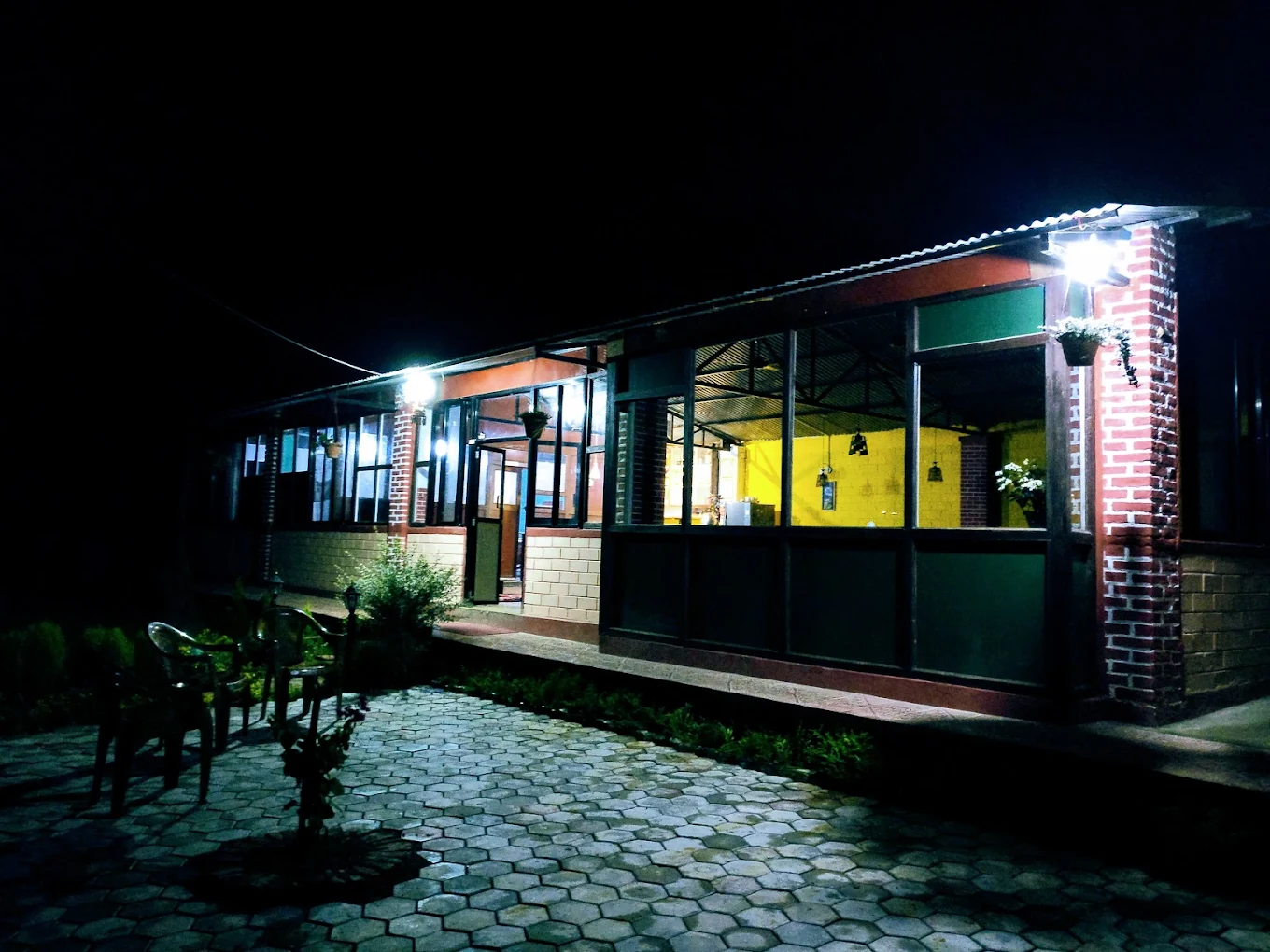 Peace Garden Restaurant Thecho outdoor garden dining area at night with warm golden lights